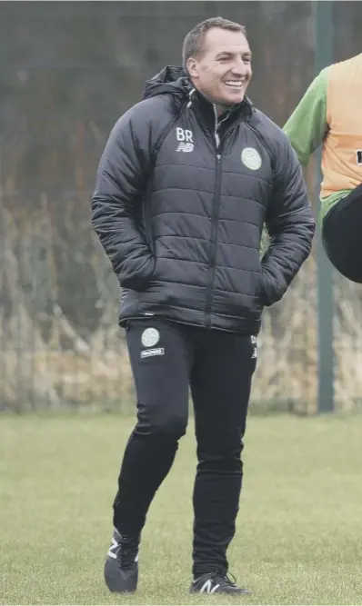  ??  ?? 0 Brendan Rodgers, left, and Kieran Tierney enjoy a joke during training. The Celtic manager says he’s