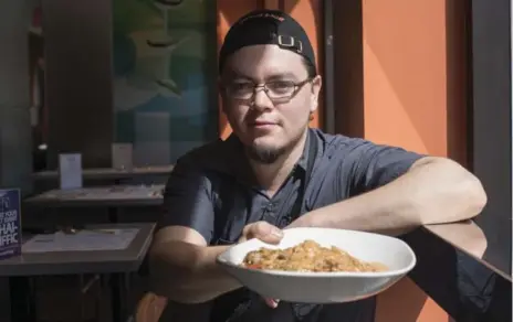  ?? J.P. MOCZULSKI FOR THE TORONTO STAR ?? Gerry Quintero, 26, chef de cuisine at Linda Modern Thai, with sister restaurant Salad King’s secret off-menu item: Thai Islamic Noodle ($12 with shrimp).