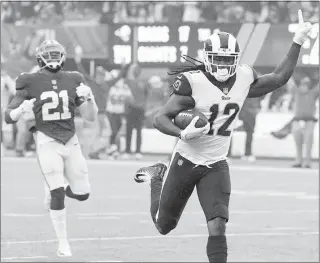  ?? BILL KOSTROUN / AP ?? Los Angeles Rams wide receiver Sammy Watkins (12) celebrates scoring a touchdown as New York Giants strong safety Landon Collins (21) looks on during their game Sunday in East Rutherford, N.J. With their 51-17 win Sunday, the surprising Rams lead the...