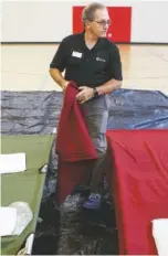  ?? STAFF PHOTO BY C.B. SCHMELTER ?? Southeast Tennessee American Red Cross Disaster Program Manager Jerry Wang preps cots Thursday in the gym at the Brainerd Youth and Family Developmen­t Center. Area organizati­ons are joining to open and operate a shelter for coastal residents fleeing Hurricane Florence.