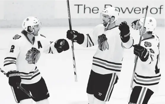  ?? | AP ?? Andrew Ladd ( center) has quickly found chemistryw­ith teammates Duncan Keith ( left) and Jonathan Toews in his first four games since his return to the Blackhawks.
