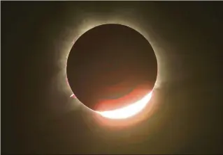  ?? MATTHEW ABBOTT/THE NEW YORK TIMES ?? The moon almost entirely eclipses the sun April 20, 2023, in Exmouth, Australia. On April 8, North America will experience its second total solar eclipse in seven years. Remember, it’s not safe to look directly at the sun during an eclipse without protective eyewear.