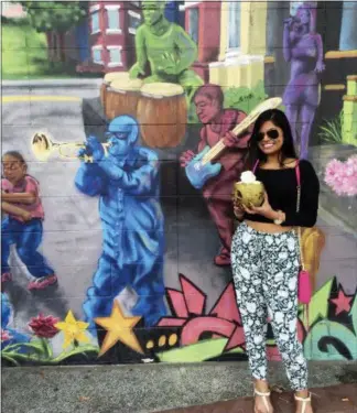  ?? MANISHA KHATTA — SHRUTI SHAH VIA AP ?? In this September 2016 photo, Shruti Shah is shown in front of a street mural in Eastern Market, Washington, D.C. Shah has used the photo before as a dating profile image.