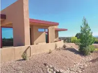  ?? COURTESY OF S. LIAKUS ?? Larga Vista Garden, Anasazi Trails: George and Sharon Arthur built sustainabi­lity into the design of their custom home and landscapin­g. Roof rainwater flows inside buttress walls to seven diversion ponds that supplement irrigation. Rock mulching prevents erosion, and 47 plant species, mostly native, soften the spare hilltop acreage.