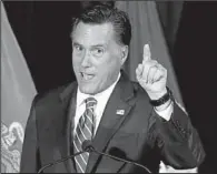  ?? AP/CHARLES DHARAPAK ?? Mitt Romney repeated his criticism of defense-spending cuts during a stop at an American Legion Post in Springfiel­d, Va.