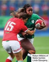  ??  ?? Robyn Wilkins of Wales tackles Linda Djougang