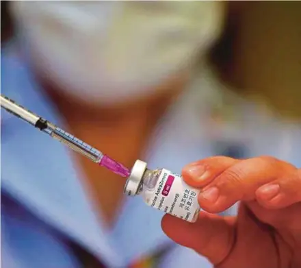  ?? EPA PIC ?? A nurse with a syringe drawing from a vial of vaccine against Covid-19 developed by AstraZenec­a at Bamrasnara­dura Infectious Diseases Institute in Nonthaburi province, Thailand, yesterday.