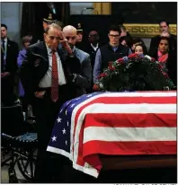  ?? AP/MANUEL BALCE CENATA ?? Former Sen. Bob Dole on Tuesday salutes the casket containing the body of former President George H.W. Bush at the U.S. Capitol in Washington.