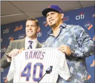  ?? Seth Wenig / Associated Press ?? Mets general manager Brodie Van Wagenen, left, poses for a picture with catcher Wilson Ramos.