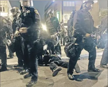  ?? Jeff Chiu Associated Press ?? OAKLAND OFFICERS subdue protesters after the guilty verdict of a BART officer in the 2009 killing of Oscar Grant. From 2005 to 2017, state law enforcemen­t officers killed 1,276 people during arrests, data show.