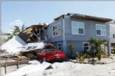  ?? WILFREDO LEE - THE ASSOCIATED PRESS ?? In this Sept. 13 photo, a house with its roof blown off by Hurricane Irma in Summerland Key, in the Florida Keys. Rising sea levels and fierce storms have failed to stop relentless population growth along U.S. coasts in recent years, a new Associated...