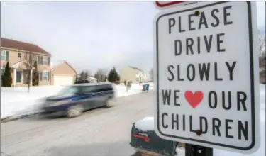  ?? ERIC BONZAR—THE MORNING JOURNAL ?? A sign posted on Avalon Drive — a densely-populated residentia­l area in North Ridgeville — reminds drivers to slow down to the posted 25 mph speed limit.