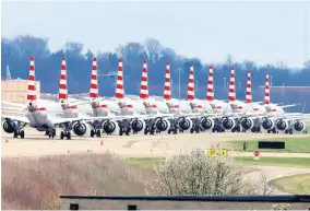  ?? AP ?? In this March 31, 2020 file photo, American Airlines planes stored at Pittsburgh Internatio­nal Airport sit idle on a closed taxiway.