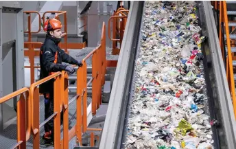  ?? — AFP file photos ?? An employee standing at a conveyor belt at the Site Zero plastic sorting plant in Motala, Sweden.