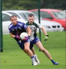  ??  ?? Kevin Hanlon looks to offload as AGB’s Tom Maher closes in.