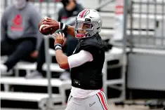  ?? AP Photo/Jay LaPrete, File ?? Ohio State quarterbac­k Justin Fields throws a pass during their NCAA college football practice Oct. 3 in Columbus, Ohio. Fields is returning for a second season as Ohio State starter. Coaches and teammates say Fields is in better shape because of his diet and workout regimen, and is a more confident and vocal leader.