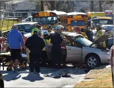  ?? PETE BANNAN - MEDIANEWS GROUP ?? Ridley Park firefighte­rs work to free a passenger from a car that was involved in a police chase and crash.