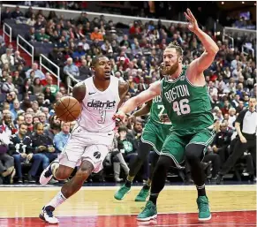  ??  ?? Eyes on the basket: Washington Wizards’ Bradley Beal (left) dribbling past Boston Celtics’ Aron Baynes during the NBA game at the Capital One Arena on Thursday. — AFP