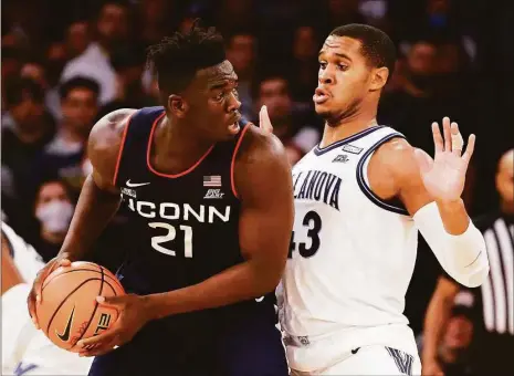  ?? Tim Nwachukwu / Getty Images ?? UConn’s Adama Sanogo (21) could be going up against Villanova’s Eric Dixon (43) three times in the regular season alone in 2022-23.