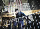  ?? BRYAN WOOLSTON THE ASSOCIATED PRESS ?? A police officer places a barricade in front of Trump Tower on Tuesday in New York.