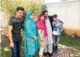  ?? THE ASSOCIATED PRESS ?? Pakistan’s Nobel Peace Prize winner, Malala Yousafzai, center, poses for a photograph with her family members at her hometown during a visit Saturday to Mingora, the main town of Pakistan Swat Valley.