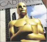  ?? MATT SAYLES/ INVISION VIA AP ?? IN THIS FEB.
21, 2015 FILE PHOTO, an Oscar statue appears outside the Dolby Theatre for the 87th Academy Awards in Los Angeles.