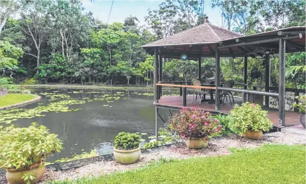  ??  ?? REEL VALUE: The owners of 27 Edward St, Atherton, have built a dam on the property and stocked it with barra fingerling­s.