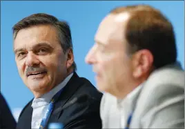  ?? AP PHOTO ?? Internatio­nal Ice Hockey Federation President Rene Fasel, left, listens as NHL commission­er Gary Bettman, right, answers a question during a news conference. Fasel says he and national hockey federation­s need to know by the end of April whether the NHL...