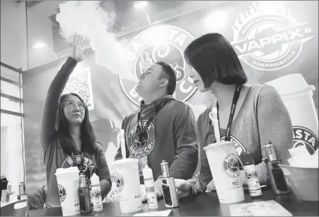  ?? PHOTOS BY WANG QIONG / FOR CHINA DAILY ?? Top and above: An exhibition promoting e-cigarettes is held last year in Beijing. Experts have called for regulation­s to be introduced covering their production and sale.