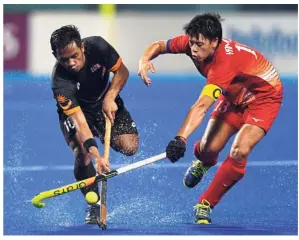  ?? — AFP ?? Making usproud: Faizal Saari (left) scored eight goals to help Malaysia claim the bronze medal in the Asian Champions Trophy in Muscat, Oman, on Sunday.