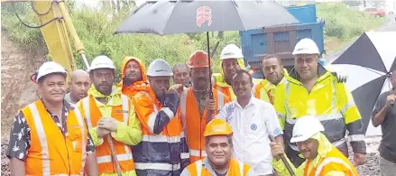  ?? Photo: Ronald Kumar ?? Assistant Minister for Local Government, Infrastruc­ture and Transport Vijay Nath (in white shirt), with Fulton Hogan Hiways workers after completing work at 10 miles on Farm Road yesterday.