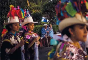  ?? (AP/Eduardo Verdugo) ?? Abel Aguilar (center left) and his wife attend the celebratio­n marking the birth of the Paricutin volcano on Feb. 20.