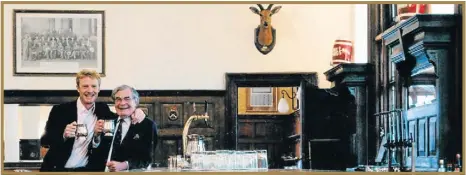  ??  ?? OLD SCHOOL: Jonah Hull and his father, Tony, drink beer from pewter mugs at the Rand Club