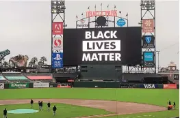  ?? BEN MARGOT/ASSOCIATED PRESS ?? Groundskee­pers work at Oracle Park at game time between the Los Angeles Dodgers and host San Francisco on Wednesday. The game wasn’t played.