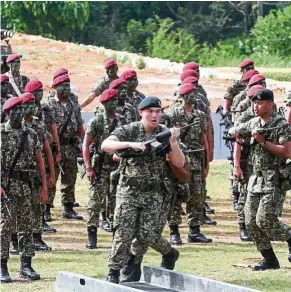  ??  ?? Tengku Amir showing his strength, courage and competence in the Armed Force during the presentati­on of credential­s ceremony to army officers at Terendak Camp, Sungai Udang, Malacca, in July this year.