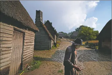  ??  ?? Museum educator Scott Atwood, playing the role of Pilgrim Stephen Hopkins, walks through Plimoth Plantation, a living history museum village, after locking up at the end of the day in Plymouth, Mass. In an article in the previous winter’s Historical Journal of Massachuse­tts, Dr. John Booss of the Yale University School of Medicine argued the “exquisite timing” of the Pilgrims’ arrival in the wake of a deadly epidemic was one of the key factors in the colony’s success.
(AP/David Goldman)