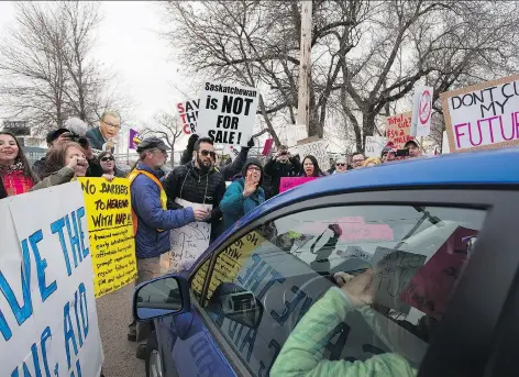  ?? KAYLE NEIS ?? More than 100 protesters blocked entrances to Prairielan­d Park in Saskatoon on Thursday evening as 1,000 guests were arriving for the Premier’s Dinner fundraiser for the Saskatchew­an Party. Traffic was at a crawl outside the venue until police arrived.