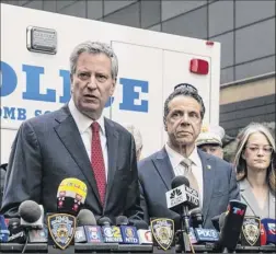  ?? Jeenah Moon / The New York Times ?? Mayor Bill de Blasio, left, with Gov. Andrew Cuomo during a news conference on the discovery of an explosive device at CNN offices in New York on Oct. 24.