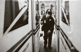  ?? Matt Rourke / Associated Press ?? A U.S. postal carrier delivers mail in Philadelph­ia. New Postmaster General Louis Dejoy has ordered mail left behind at distributi­on centers if it would delay carriers.