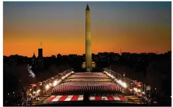  ?? SUSAN WALSH / ASSOCIATED PRESS ?? A field of flags is spread across the National Mall, with the Washington Monument in the background, on Tuesday evening, ahead of today’s 59th Presidenti­al Inaugurati­on.