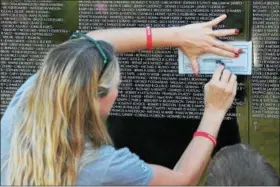  ?? KRISTI GARABRANDT — THE NEWS-HERALD ?? Melinda Allen of Beallsvill­e, came to The Wall to get etchings the etchings of the names on The Wall from her city to take back for their family members.