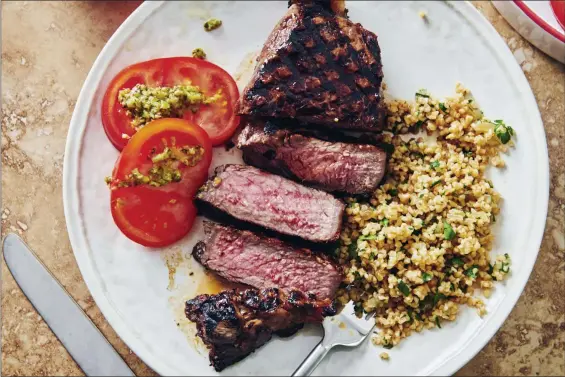  ?? CHEYENNE COHEN — KATIE WORKMAN VIA AP ?? This shows grilled marinated New York Strip Steak.