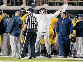  ?? Ezra Shaw / Getty Images ?? Jeff Tedford (center) had his worst season in 11 years as Cal’s head coach, ending with five straight losses, the last two by a combined score of 121-31.