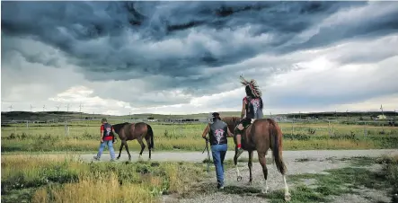  ?? PHOTOS: LEAH HENNEL ?? Team Lone Wolf, practising at Piikani Nation last month, is competing in Indigenous relay racing at the Stampede. It involves riders in full regalia riding bareback and is a first for Stampede. It runs for three nights starting Tuesday.