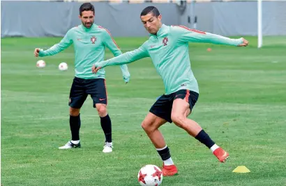  ?? — AFP ?? Portugal’s Cristiano Ronaldo and Joao Moutinho take part in a training session in Saint Petersburg.