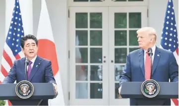  ??  ?? Trump looks on as Abe speaks during a joint press conference in the Rose Garden of the White House. — AFP photo