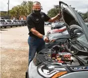  ?? Marie D. De Jesús / Staff photograph­er ?? Edward Jackson Davis of Classic Chevrolet shows what’s under the hood of a Bolt EV in Sugar Land.