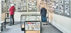  ??  ?? Top: Slipper Lake then and now in images which form part of the current exhibition at Emsworth Museum; above left, visitors enjoy the ‘past and present’ display; right, a painting of PG Wodehouse by Carol Millard