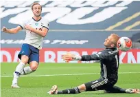  ??  ?? Spurs’ Harry Kane beats Kasper Schmeichel.