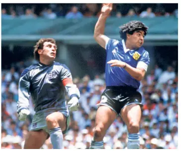  ?? THE HINDU PHOTO
LIBRARY ?? 1986: When Steve Hodge miskicked a clearance Diego Maradona and England captain Peter Shilton leapt high for the ball close to the penalty box. Maradona made up for what he lacked in inches by clearly raising his right hand above Shilton’s head and palming the ball into the net.